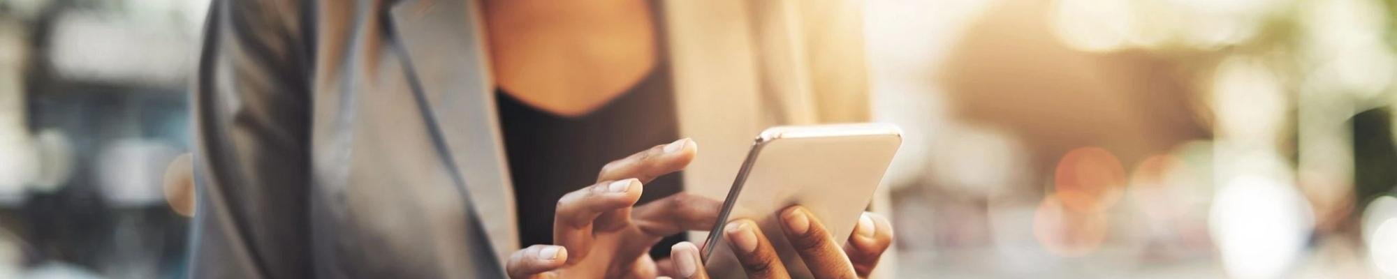 woman using smartphone outside from Flooring Connection Outlet in San Antonio
