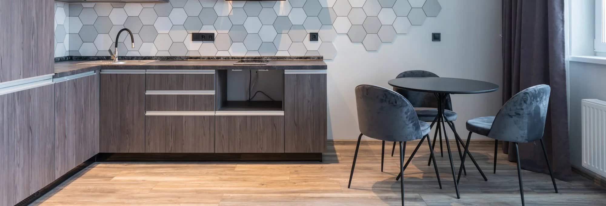 modern grey kitchen with beautiful hardwood floors in San Antonio, TX | Flooring Connection Outlet |