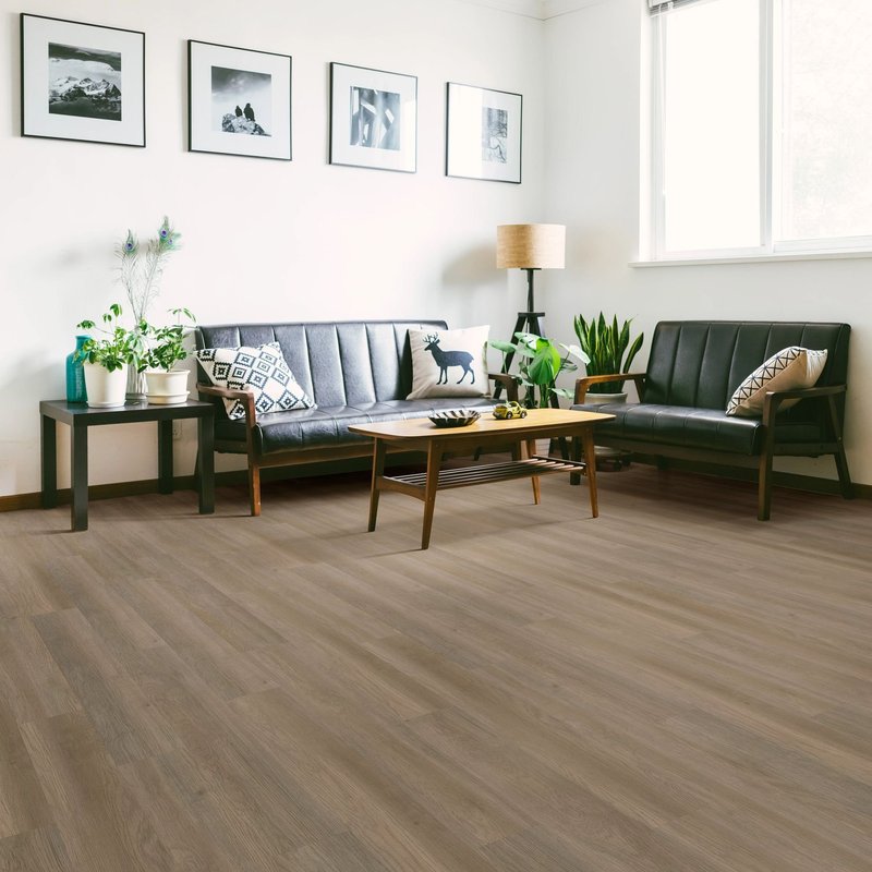 black leather couch with brown vinyl flooring by Flooring Connection Outlet in San Antonio, TX