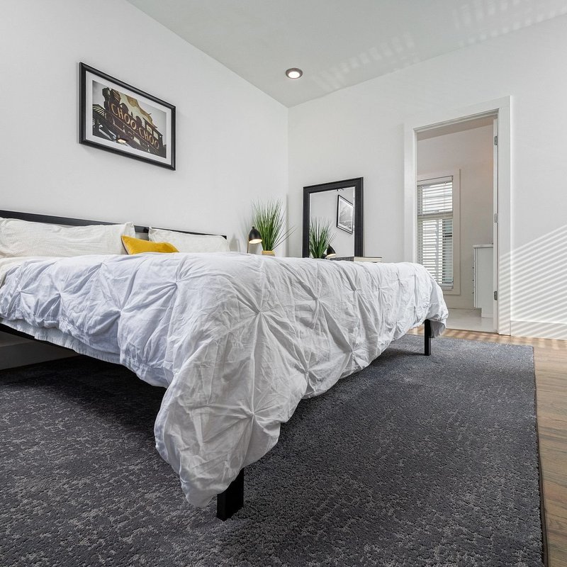 white bed and gray carpet by Flooring Connection Outlet in San Antonio, TX